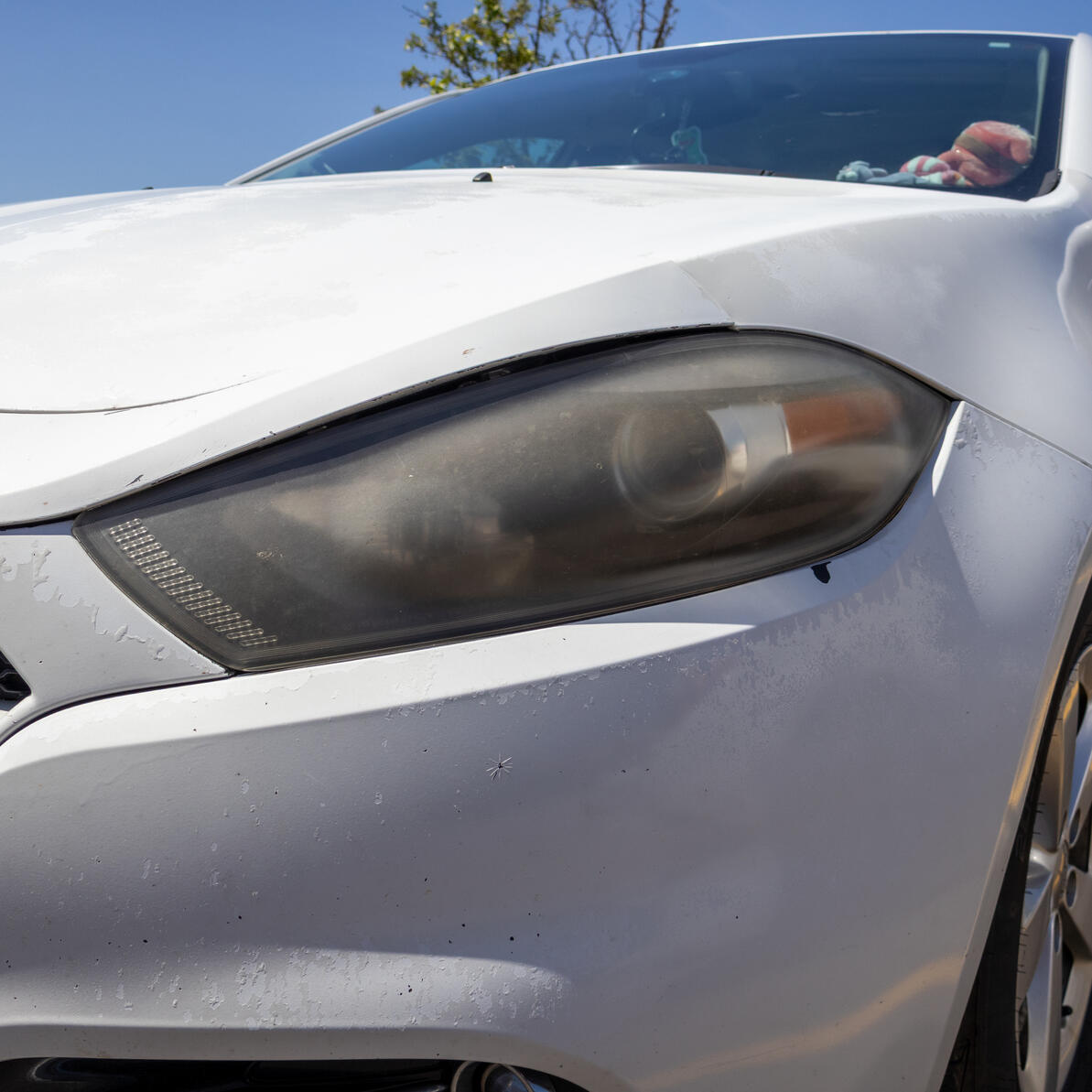 Headlight Before A dodge dart headlight that is very worn down, faded, and yellow.